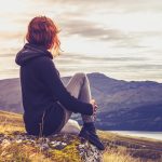 Woman Admiring Sunset from Mountain