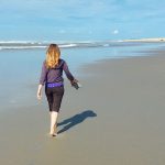 Katie Dwaileebe, Fonder of Wellness to a Tea, Walking on Beach