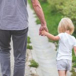 Grandfather Holding Hands with Granddaughter